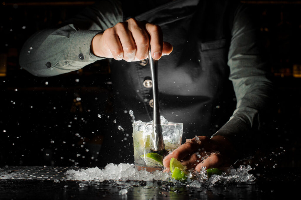 bartender smashing ice lime juice
